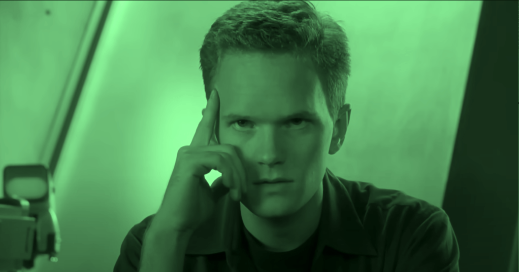 Neil Patrick Harris in Starship Troopers, wearing a militarized uniform—satirizing authoritarianism and blind nationalism through a straight-faced lens.