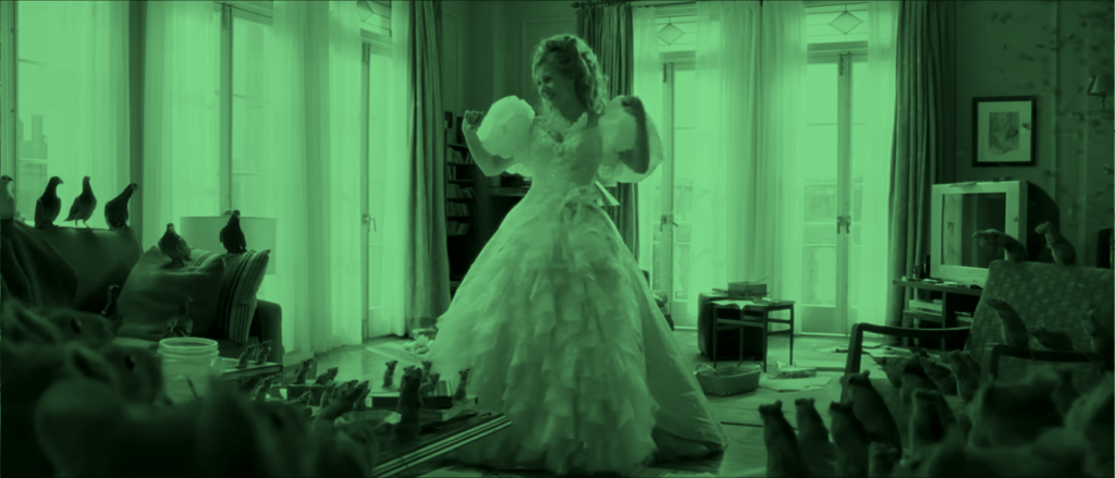 Giselle in full princess gown stands in a cluttered modern apartment in Enchanted, highlighting the contrast between fantasy tropes and reality.